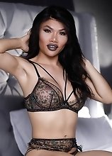 Xena Lynn the hot oriental t-girl with a huge dick pleasures herself until she cums hard